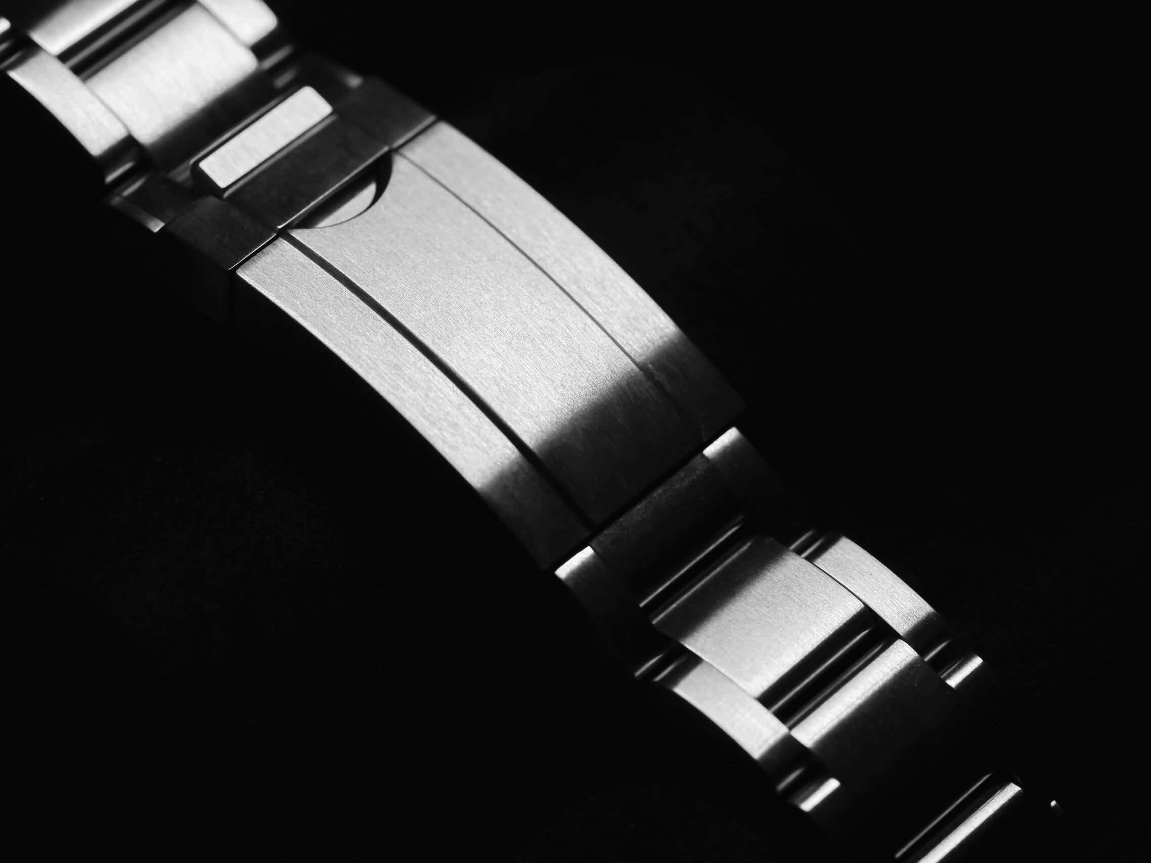 Monochrome closeup of watch buckle hardware
